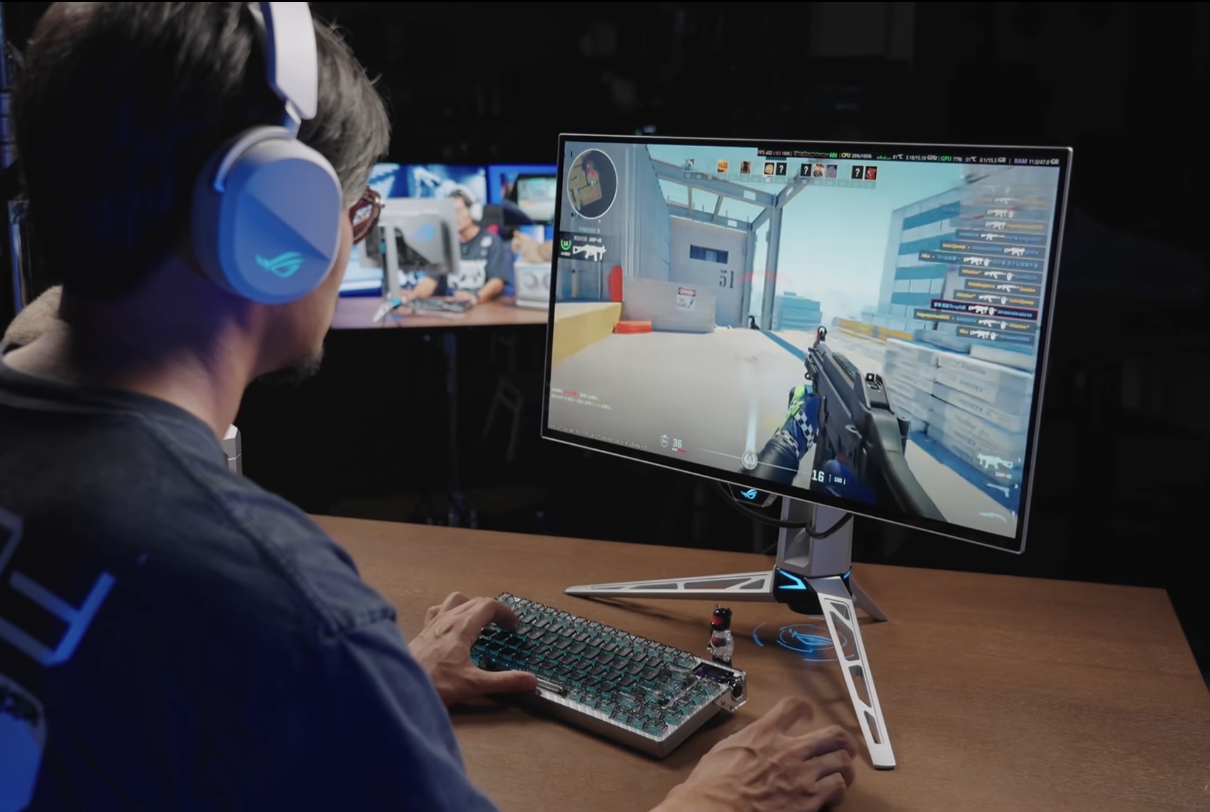 Man wearing ASUS ROG headphones playing a video game on an ASUS ROG monitor.