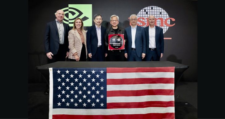 NVIDIA and TSMC executives with Blackwell Made in America plaque on stage with American flag.