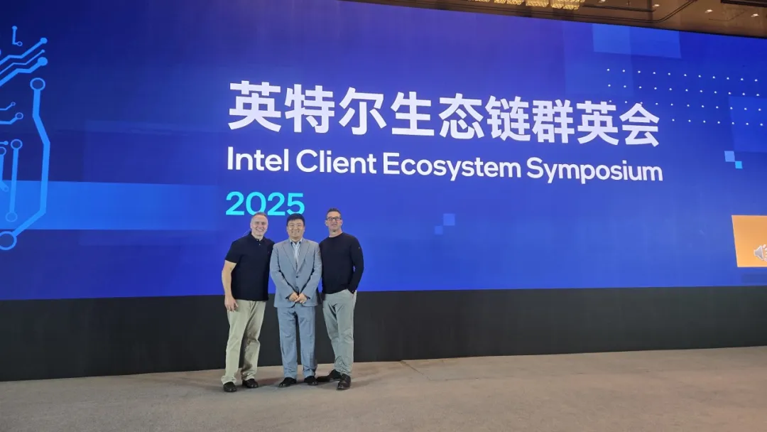 Intel Client Ecosystem Symposium 2025 stage with three people standing in front.