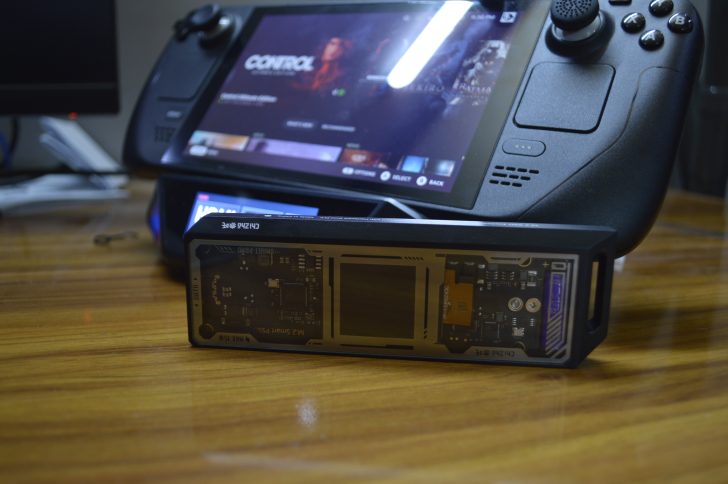 M.2 Smart PSSD marked CH SN740 on desk near Steam Deck displaying game titles.