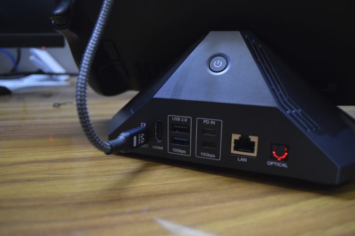 Unbranded docking station on desk showing HDMI, USB 2.0, PD IN, LAN, and optical ports with labeled “10Gbps” and “40Gbps”.