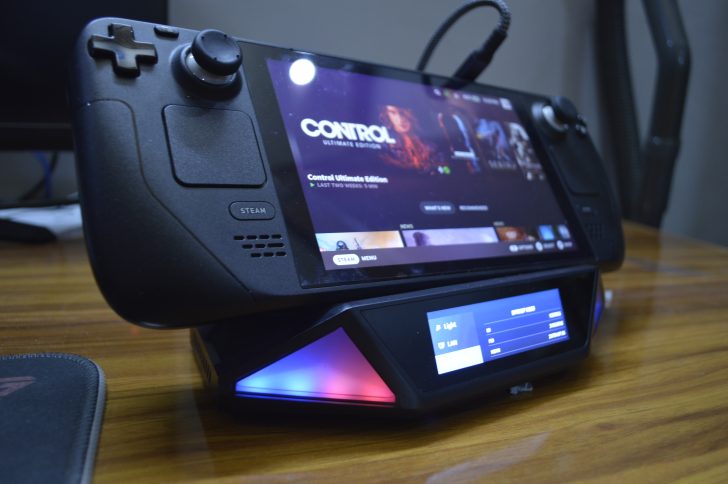 Steam Deck displaying Control Ultimate Edition sits on a charging dock with status screen showing STARDREAMER.