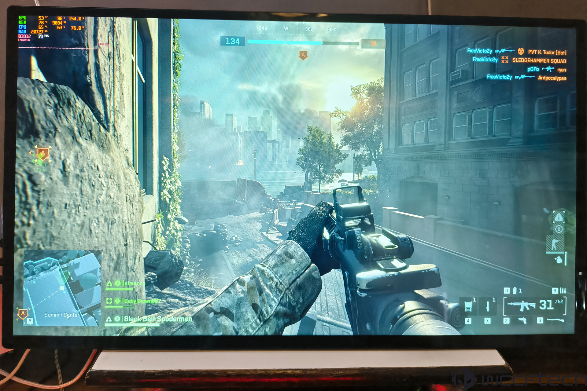 Battlefield 2042 game screen on monitor with CPU temperature and usage stats on top left.
