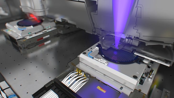 Semiconductor lithography machine in operation with purple laser beam, microchip wafer on platform, and visible Caution label.