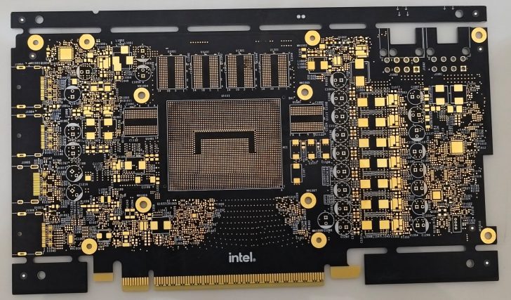 Intel circuit board with gold and black tracings on a white surface.