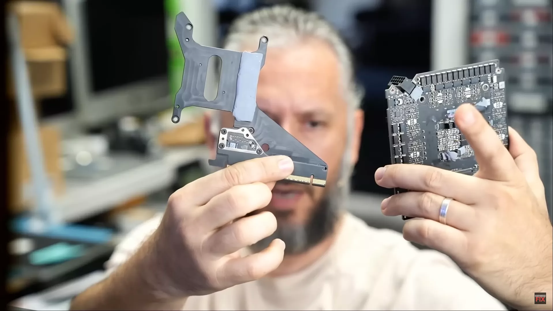 Unbranded circuit board and heatsink held by a person.