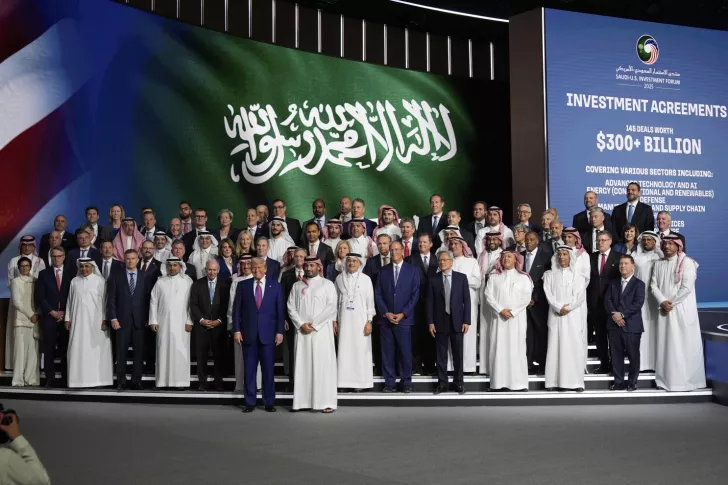 Group of people on stage in front of a screen displaying Saudi-U.S. Investment Forum 2023 and investment agreements $300+ billion.