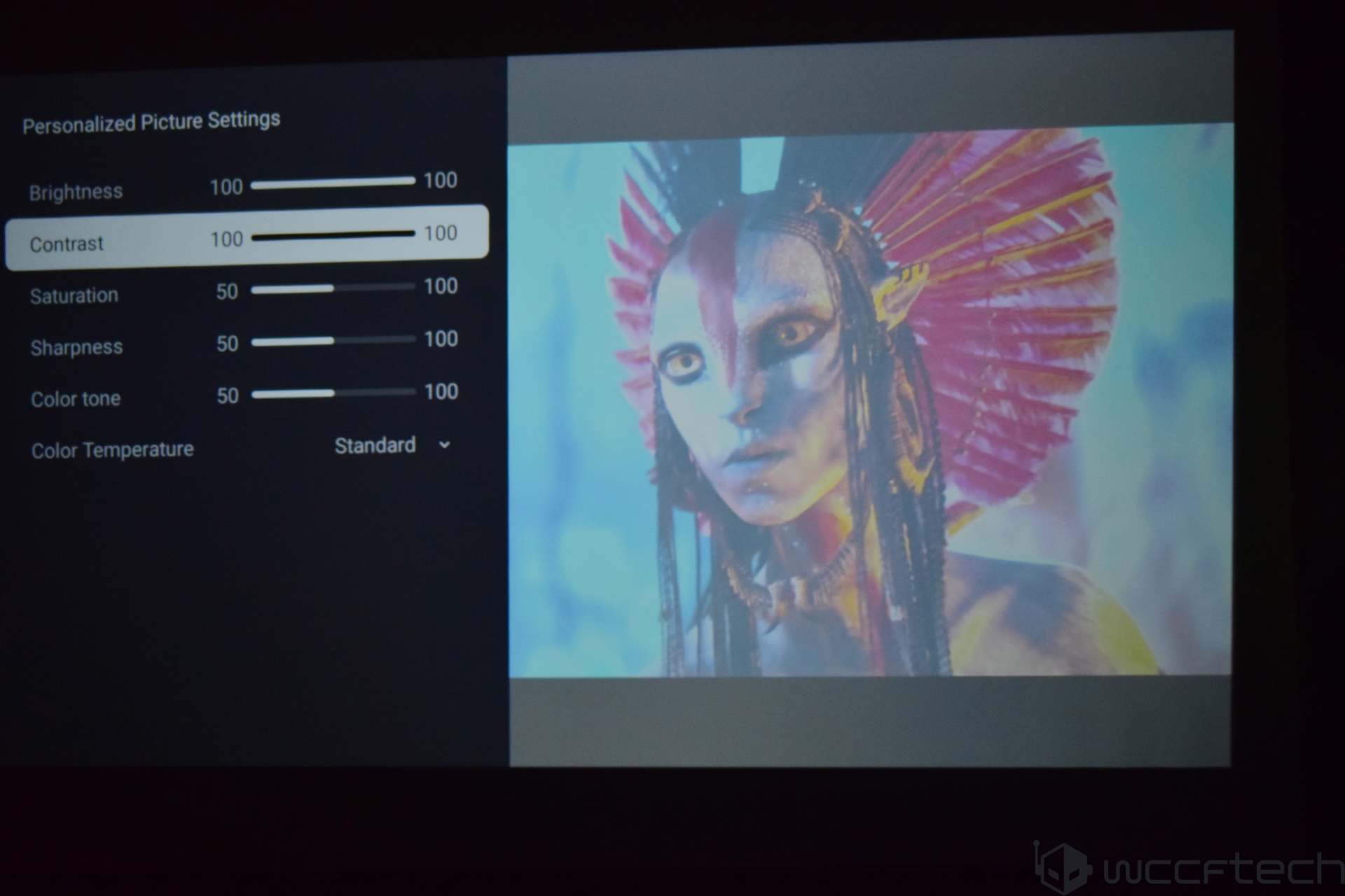A display screen shows a character from Avatar on the right, with personalized picture settings on the left including 'Contrast' set to 100.