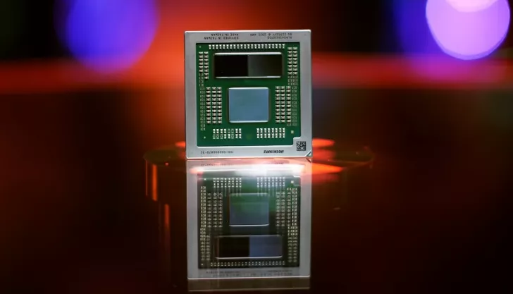 A close-up of an AMD CPU labeled 'Diffused in Taiwan Made in 2022' with a reflection on a shiny surface, set against a blurred red and purple background.