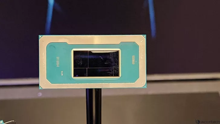 A close-up of an Intel chip with a visible label '01084' on a stand.