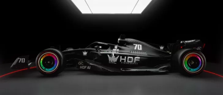 A sleek, black race car with the text 'HOF RTX 50 Series' features rainbow-colored wheel rims and several 'HOF AI' logos under bright overhead lighting.