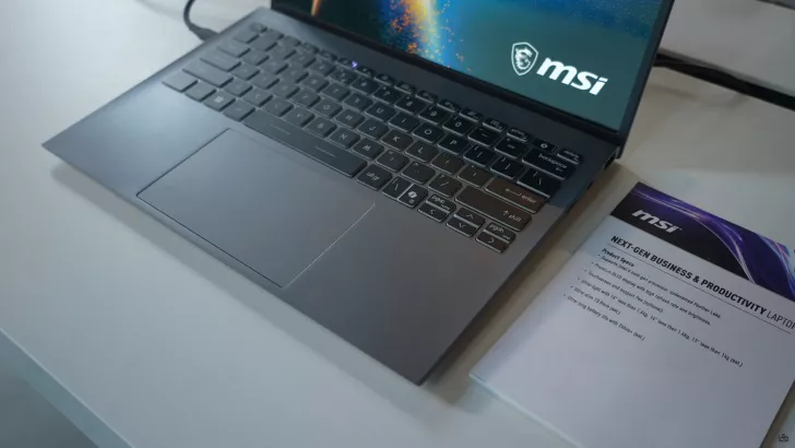 An MSI laptop is displayed next to a document titled 'Next-Gen Business & Productivity Laptop' with specifications mentioning 'Panther Lake' and 'Premium OLED.'