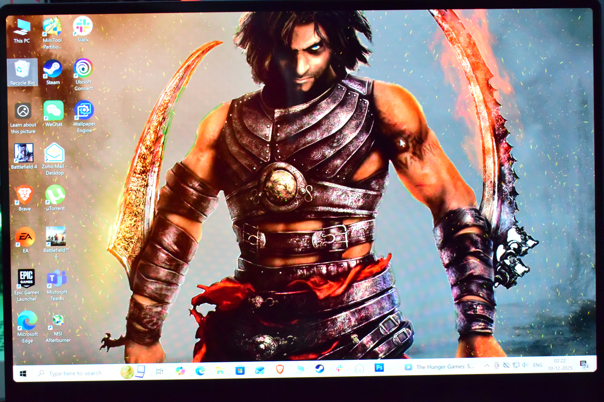 A desktop screen displaying a character from Prince of Persia: Warrior Within with various application icons like Steam, Slack, and EA visible on the left side.
