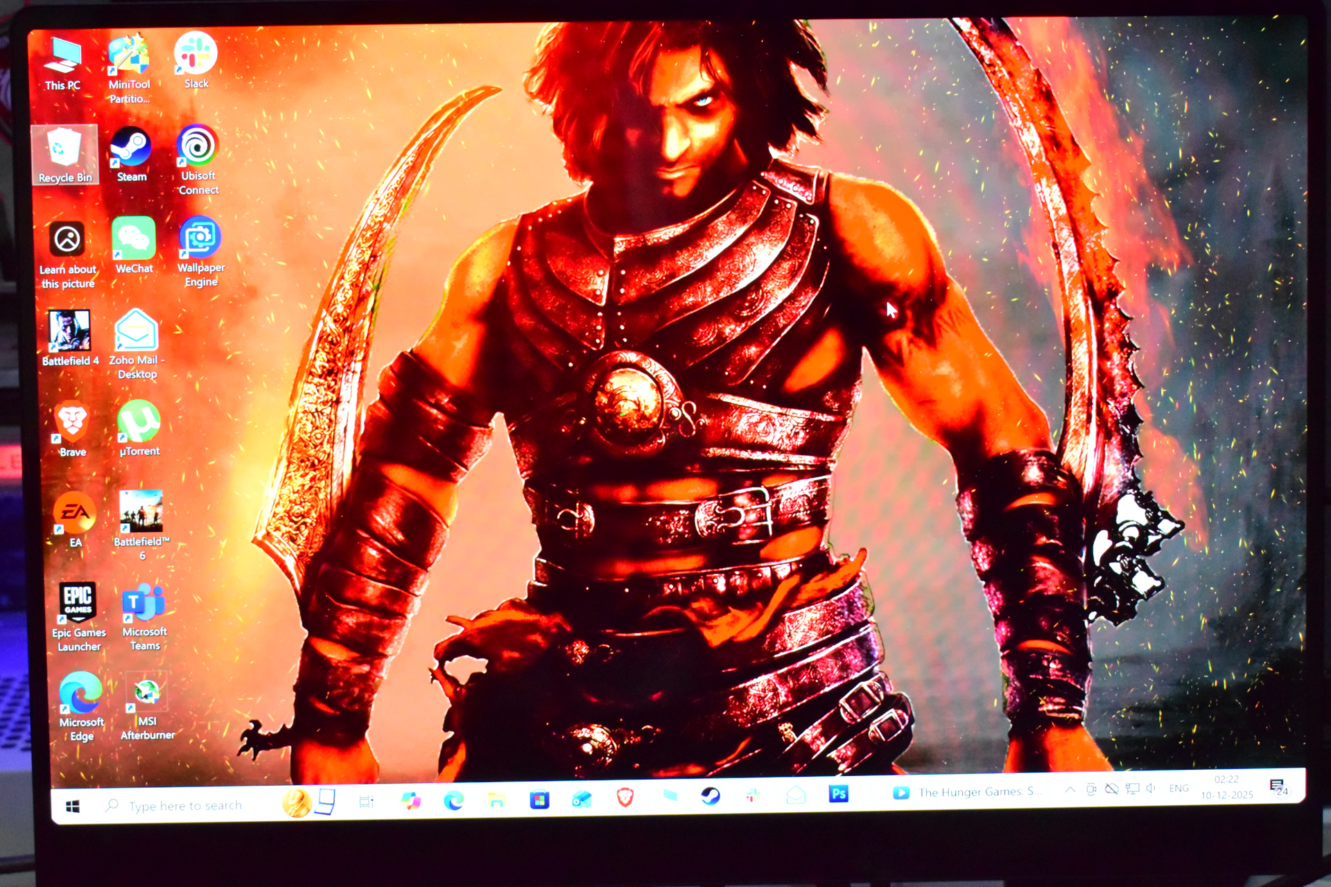A desktop screen displaying a character from the game Prince of Persia: Warrior Within with various app icons on the left, including Steam, Ubisoft Connect, and Battlefield 4.