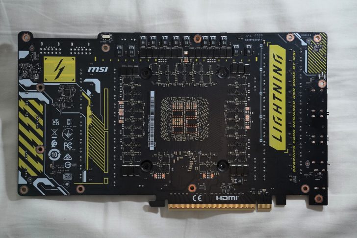 The back view of an MSI GTX 980 Ti LIGHTNING graphics card shows intricate circuitry with 'LIGHTNING' branding and various certification logos.