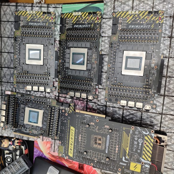 Five Lightning-branded graphics card PCBs are laid out on a table, featuring visible chipsets and multiple ports.